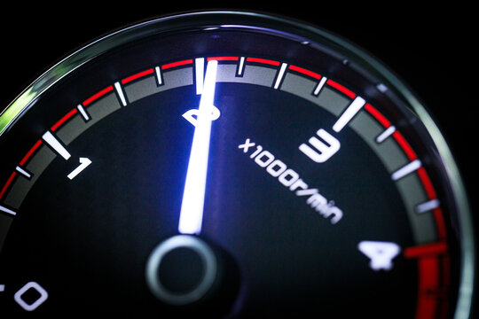 Close-up of a diesel truck's dashboard and tachometer. It represents the power and durability of a work vehicle, with a clear focus on the round engine meters.