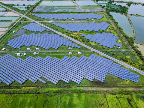 Aerial view drone shot scenic landscape of a road passing through a solar farm in Thailand