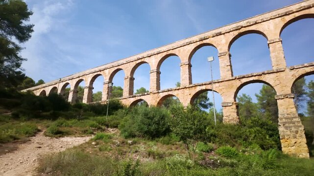 Roman aqueduct of Tarragona standing under blue sky