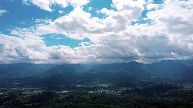 Dramatic mountain landscape beneath swirling thunderclouds and mist