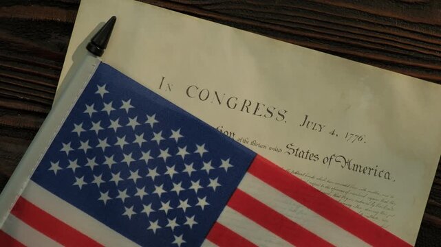 United States Declaration of Independence and American flag on wooden table