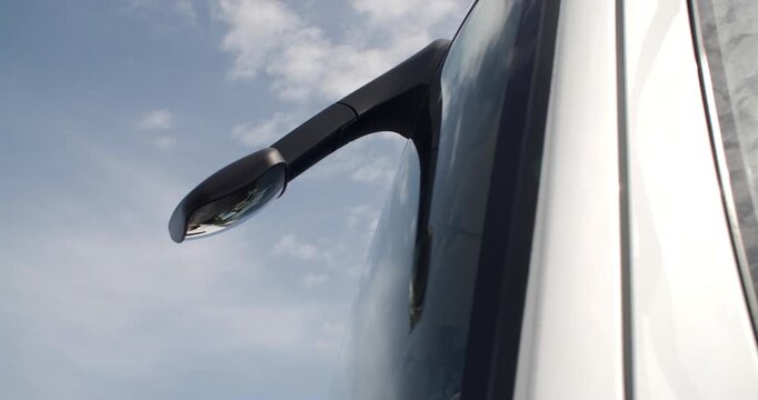Driver front visibility mirror on modern truck  blind spot cloud reflections on window
