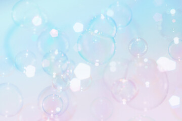 Obraz premium Beautiful Clear Colorful Soap Bubbles Floating in The Air. Celebration Festive Backdrop. Freshness Soap Suds Bubbles Water. Blue and White Gradient Textured. 