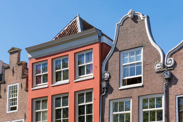 Row of gables showing step gable, cornice facade and neck gable of canal houses on Oudegracht in city center of Utrecht, Netherlands © TasfotoNL