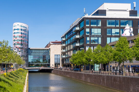 Modern Poortgebouw architecture and Primark building along restored Catharijnesingel canal in Utrecht, Netherlands