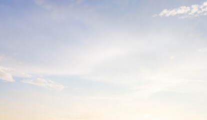 Beautiful bright sky with soft white clouds at sunrise, abstract background,Beautiful sky background with soft white clouds and gentle warm sunlight in the morning. Abstract pastel blue and yellow sky © banjongseal324