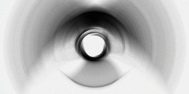 Abstract black and white tunnel effect with light in center creating illusion of speed and movement for futuristic concepts.