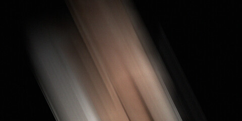 Abstract blurred background with streaks of light and muted colors, creating a sense of speed and motion in dark space. © md