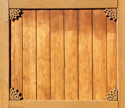 Vintage wooden shutter with rustical naive handmade decor. Retro wood door with simple hand-carved decor. Timber shutters with folk-style carvings. Rustic artisan ornaments. Simple handmade motifs