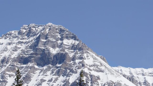 Summit ridge of barren snowy Rocky Mountain alpine peak, background