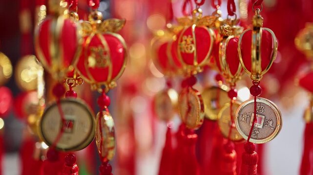 Traditional Vietnamese Tet holiday decoration close up. Red and golden lucky feng shui charms with oriental coins and tassels for Lunar New Year at a street market in Nha Trang, Khanh Hoa, Vietnam.