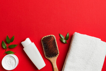 Fototapeta premium cosmetic for hair care, cream and towel on a colored background top view. flat lay