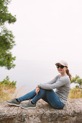 Fototapeta premium Coastal traveler woman enjoying serene horizon