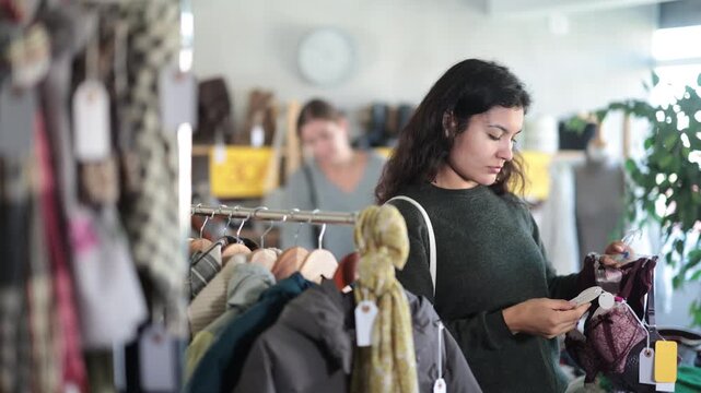 Attractive latina female customer choose new bra in big boutique