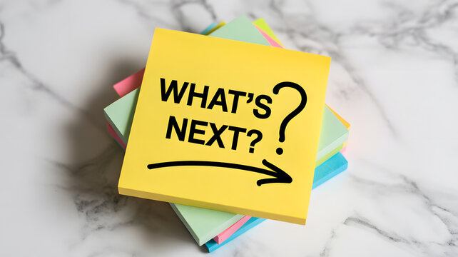 A stack of colorful sticky notes with a yellow note on top that says What's Next