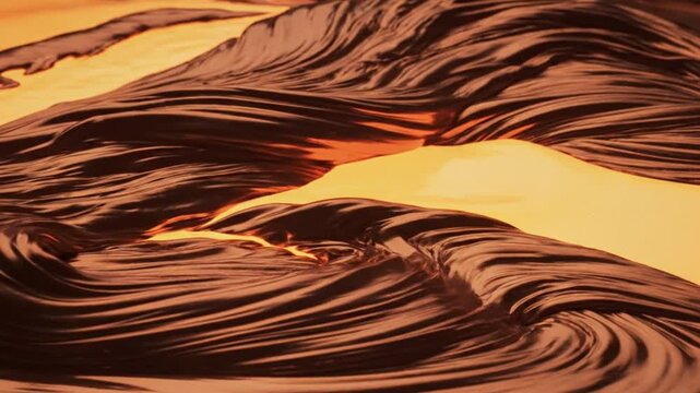 Closeup of molten dark chocolate swirling in a wave pattern