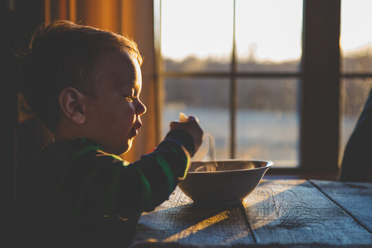 Young Boy Eating Warm Soup