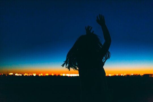 Silhouette of Girl Dancing in Twilight