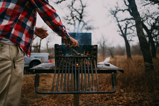 Man Starting Fire in Camping Oven