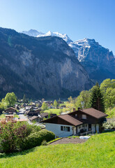 Fototapeta premium Famous Lauterbrunnen town and Staubbach waterfall, Bernese Oberland, Switzerland. Valley with green meadows. 