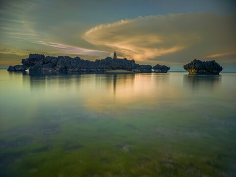 &ldquo;Whispers of Sunset at Tiang Bendera Beach, Rote Island &mdash; where silent rocks meet the glowing horizon.&rdquo;