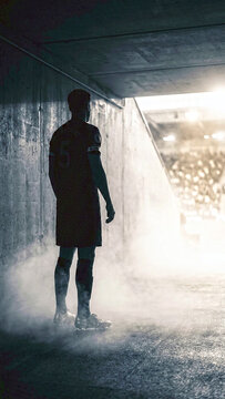 Silhouette of a Professional Soccer Player in Stadium Tunnel Before Match