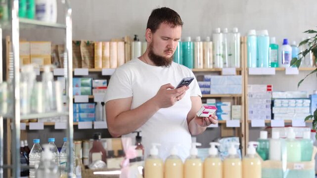  Young man buyer scanning qr code for box of paracetamol tablets in pharmacy