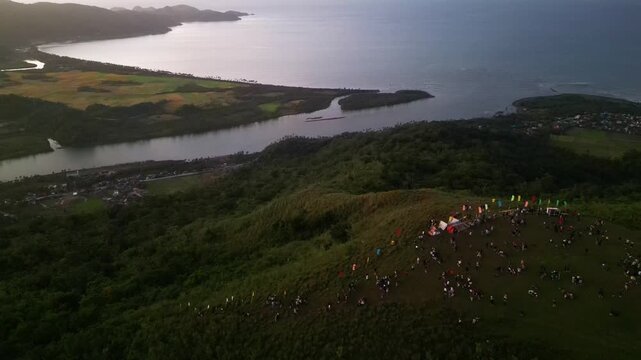 Aerial view of hikers and tourists gathered on Mount Lantad summit in Guinobatan, Bato, Catanduanes during sunrise