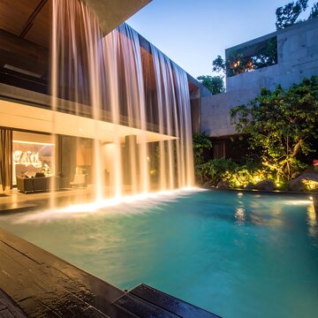 Modern architectural design with cascading water feature and swimming pool