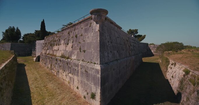 Corner stone fortress wall with grassy passages at Pula Castle.