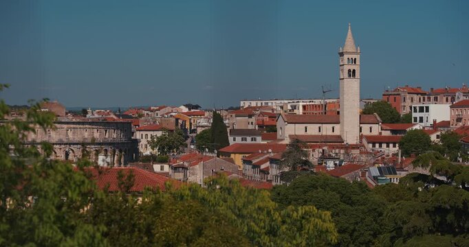 Pula Arena and the bell tower of the Church of St Anthony rise above the city rooftops viewed from Pula Castle.