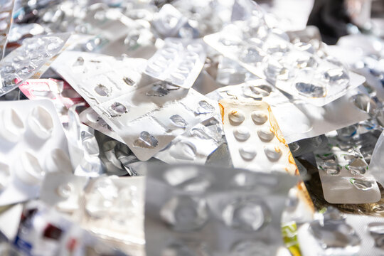 Close up of a large pile of empty aluminum blister packs from pills and medication ready for recycling.