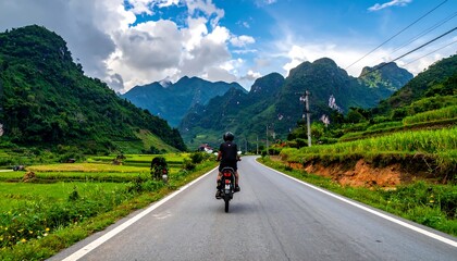 Obraz premium Motorcyclist riding through scenic mountain landscape under cloudy sky