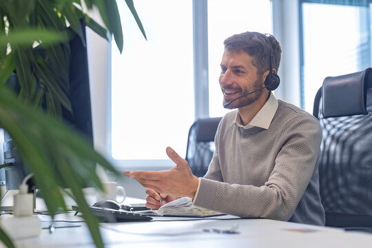 Smiling friendly handsome male call center operator.