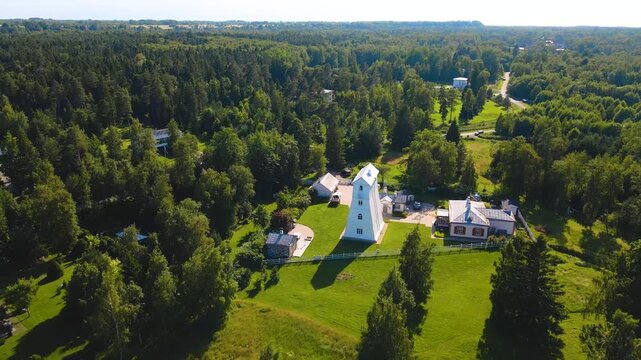 Drone Shot Flying Away from the Old Wooden Suurupi Rear Lighthouse in Estonia on a Summer Day