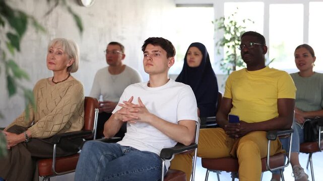 Guy teenager listens to lecture while sitting on chair. High quality 4k footage