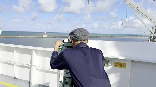 Ship Navigation officer get visual bearing to lighthouse by pelorus from the navigation bridge wing for correction gyro compass error. 