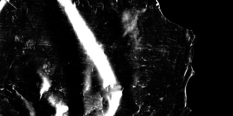 Shiny stained metallic surface with a grunge black and white style featuring heavy contrast bright light reflections, scratches dust particles and a dark textured abstract background © sutthichai