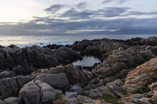 sunset light over rocky coastline of DeKelders, Gansbaai, South Africa