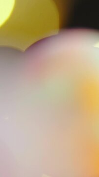 Slide over colorful marbles on glass surface macro shot