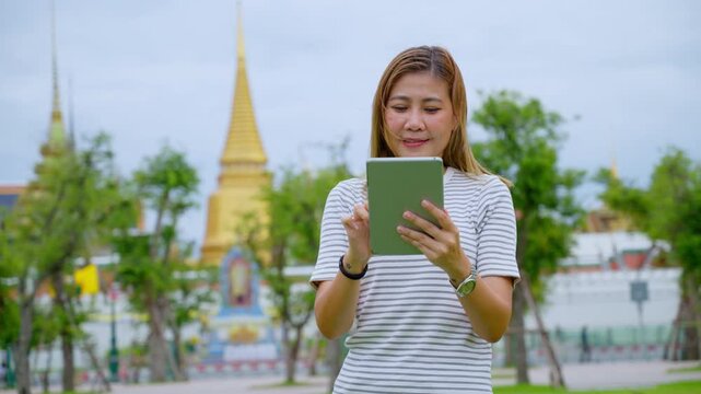 Happy Solo Female Traveler Exploring Ancient Temple Ruins in Thailand during Summer Vacation