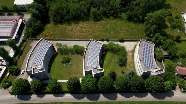 Modern environmental monitoring facility in northern Italy. Industrial buildings with solar panels and climate control systems.