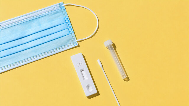 rapid antigen test for infectious disease diagnostics. Medical nasal swab kit with face mask on yellow background. Healthcare screening process and pandemic prevention health safety tool