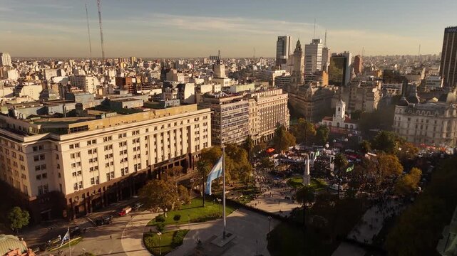 Plaza de Mayo protest with financial district skyline in background in Buenos Aires, Argentina. Aerial drone view