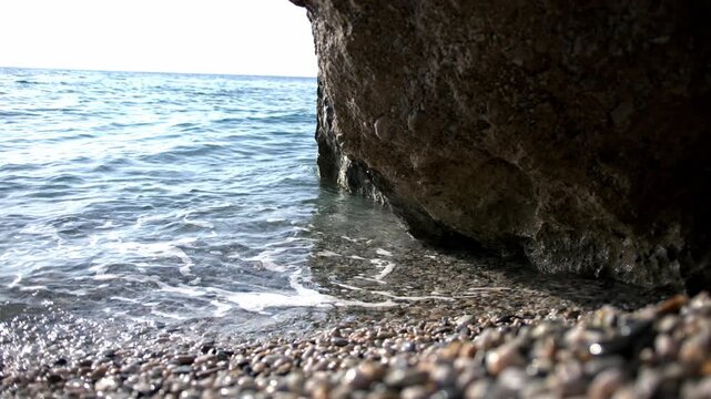 Sea Waves Hitting Pebble Beach Near Rock in Varigotti