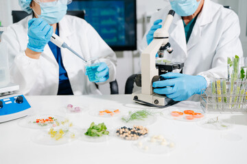 Fototapeta premium Female nutritionist in lab coat analyzing food and writing in notebook. Healthy eating, organic testing, and nutrition science