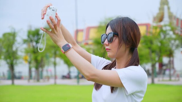 Happy Solo Female Traveler Exploring Ancient Temple Ruins in Thailand during Summer Vacation