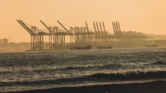 Oman Salalah, 2025-12-27 - Industrial Port Cranes at Sunset in Salalah