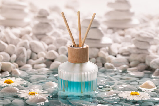 Aromatic diffuser fragrance on the coast of white stones.