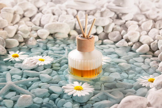 Aromatic diffuser fragrance on the shore of sea ??white stones.